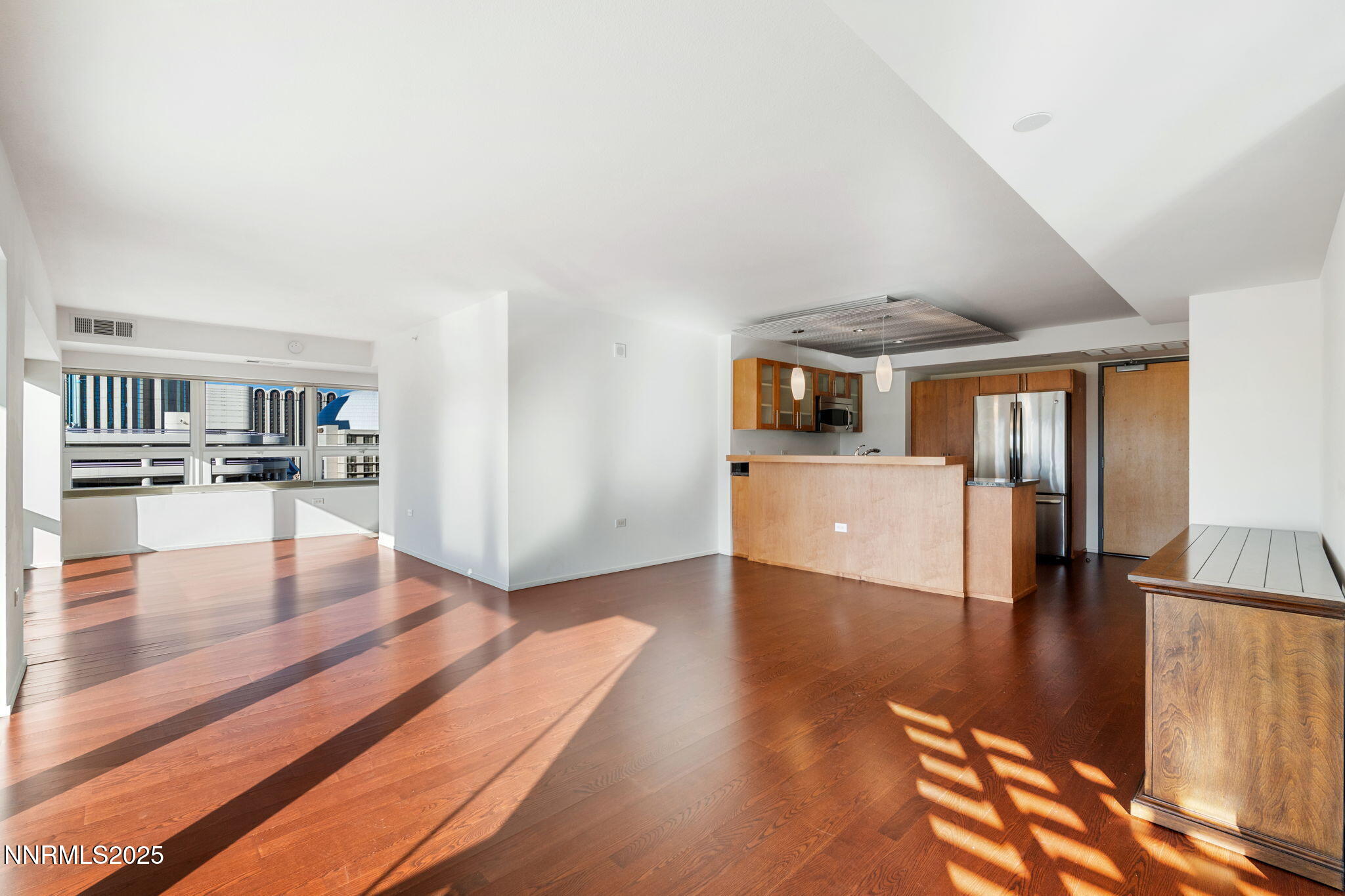 255 North Sierra Street, Unit 1012 Reno, NV 89501 - Photo 11 of 32 a view of a living room with kitchen furniture and wooden floor