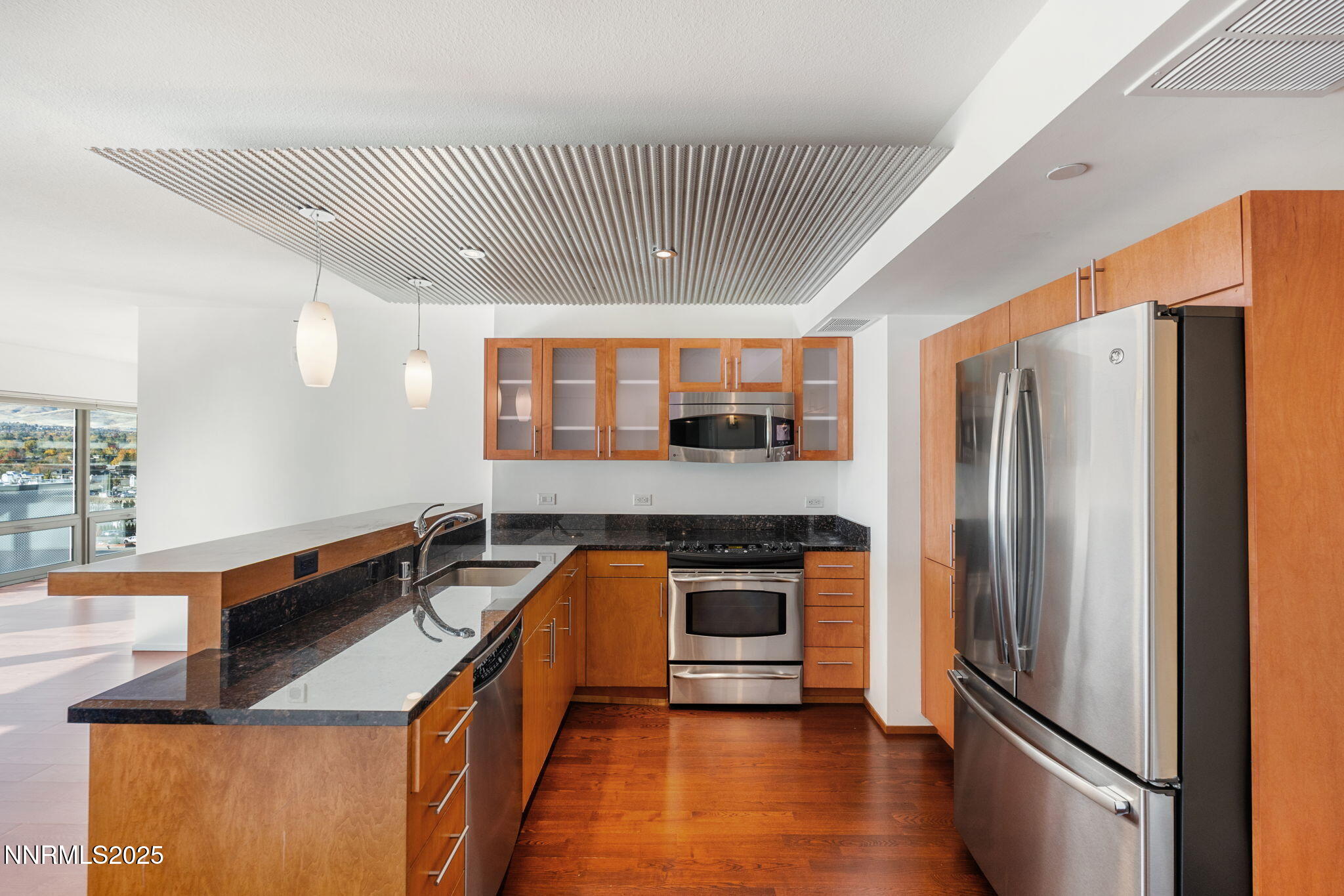 255 North Sierra Street, Unit 1012 Reno, NV 89501 - Photo 5 of 32 a kitchen with stainless steel appliances granite countertop a refrigerator a sink and a stove