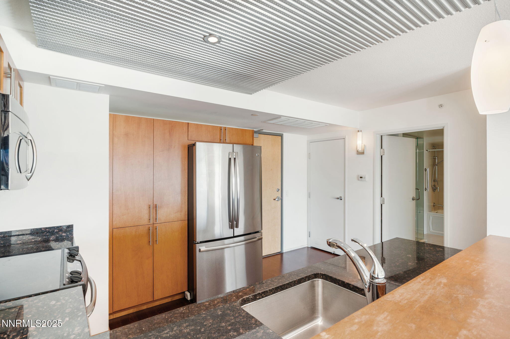 255 North Sierra Street, Unit 1012 Reno, NV 89501 - Photo 6 of 32 a kitchen with a refrigerator and a sink