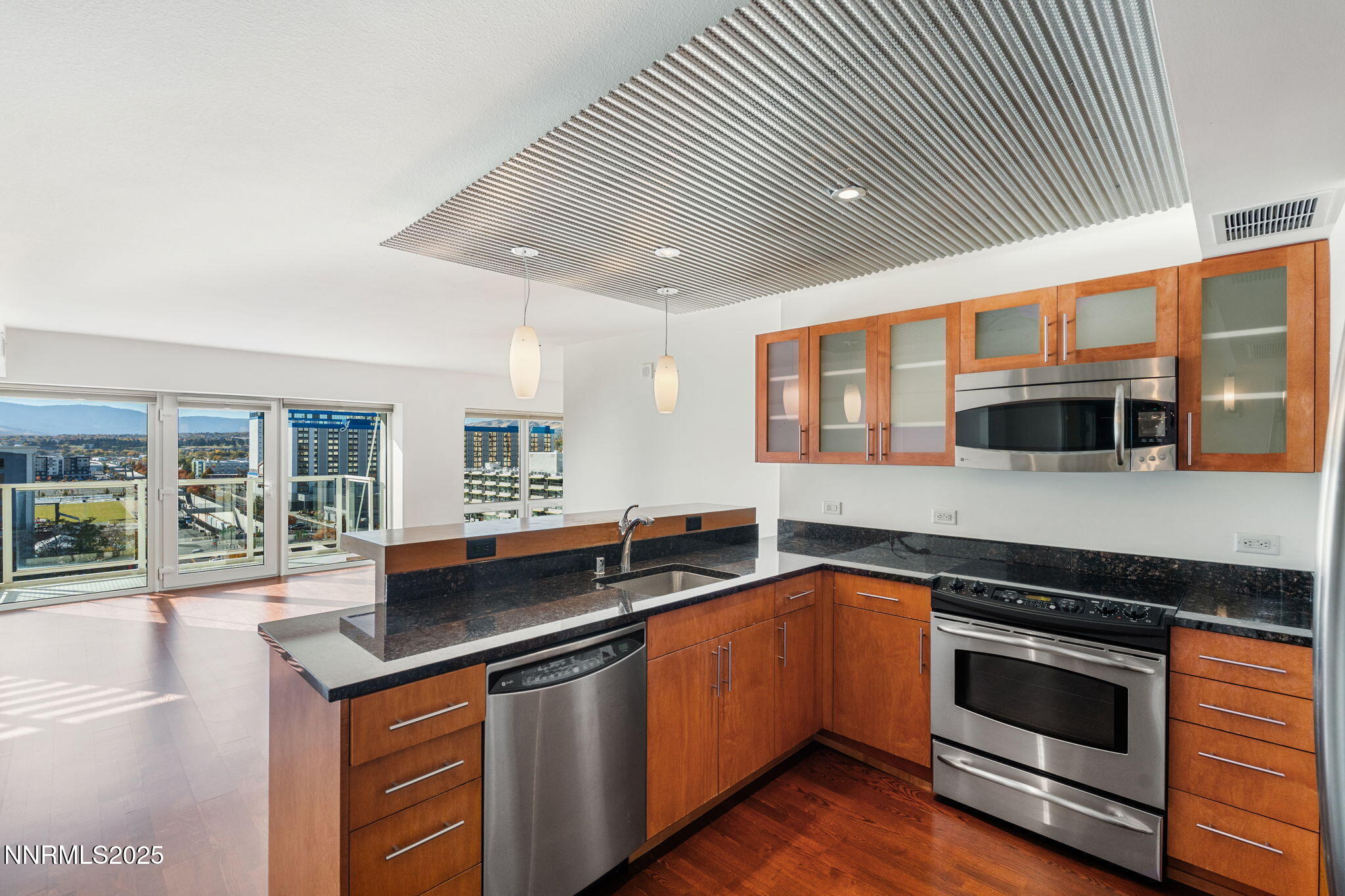 255 North Sierra Street, Unit 1012 Reno, NV 89501 - Photo 8 of 32 a kitchen with stainless steel appliances granite countertop a sink and stove top oven