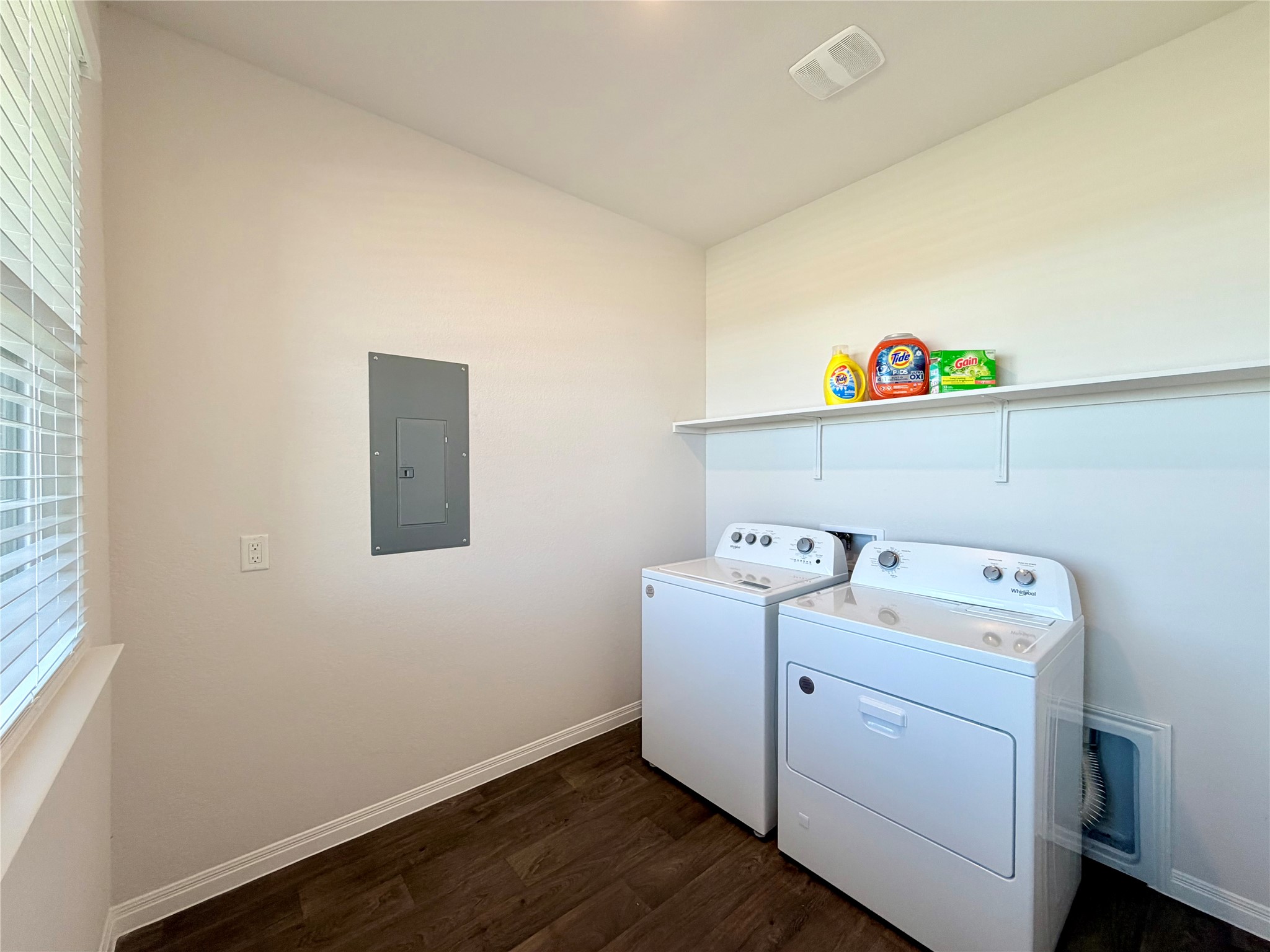 129 Saide Street Georgetown, TX 78626 - Photo 26 of 36 Rich wood floors and a convenient utility shelf anchor this functional laundry space.