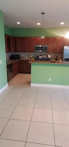 a kitchen with a cabinets a sink and a stove