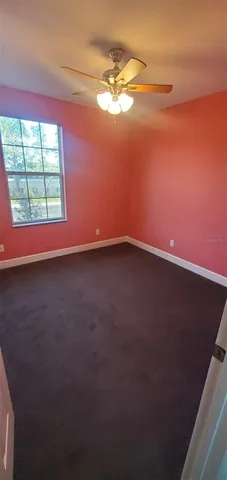 a view of an empty room and a window