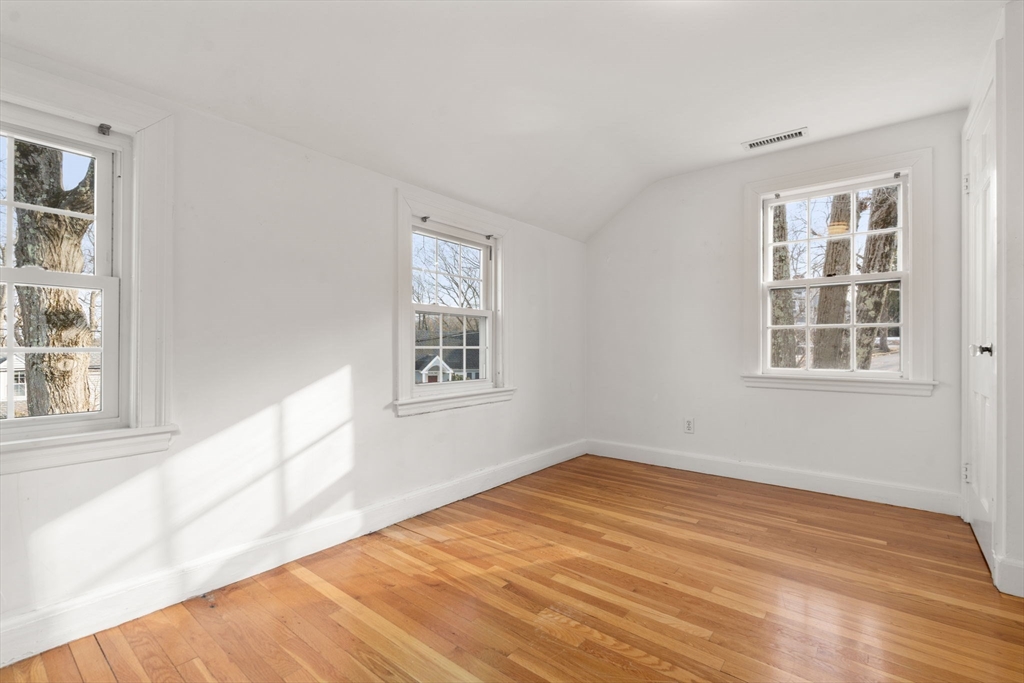 73 Roundwood Road Newton, MA 02464 - Photo 16 of 42 a view of empty room with wooden floor and fan