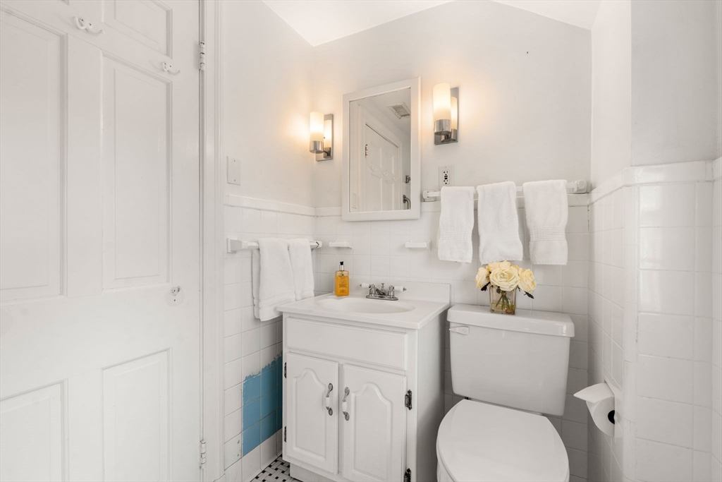 73 Roundwood Road Newton, MA 02464 - Photo 18 of 42 a white toilet sitting next to a bathroom sink