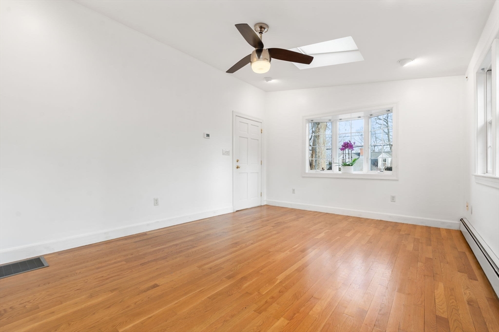73 Roundwood Road Newton, MA 02464 - Photo 22 of 42 an empty room with wooden floor and ceiling fan