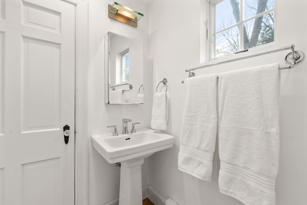 73 Roundwood Road Newton, MA 02464 - Photo 23 of 42 a bathroom with a sink a mirror and a shower