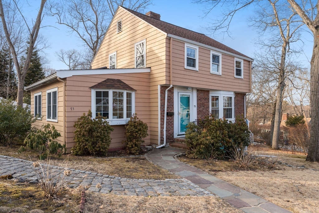 73 Roundwood Road Newton, MA 02464 - Photo 26 of 42 a front view of a house with garden