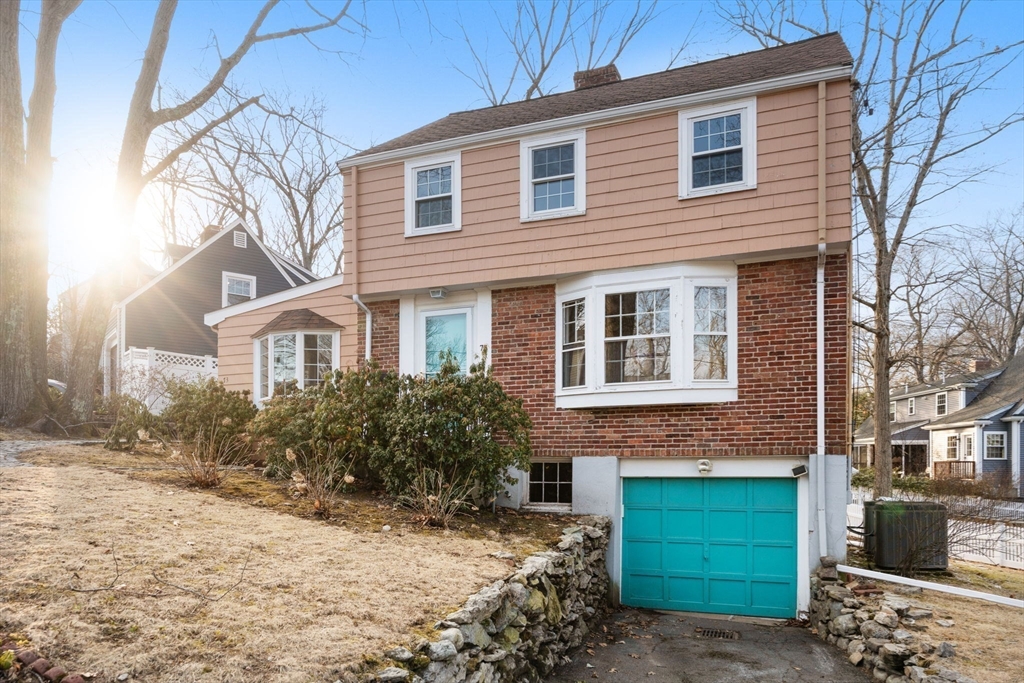 73 Roundwood Road Newton, MA 02464 - Photo 27 of 42 a front view of a house with a yard