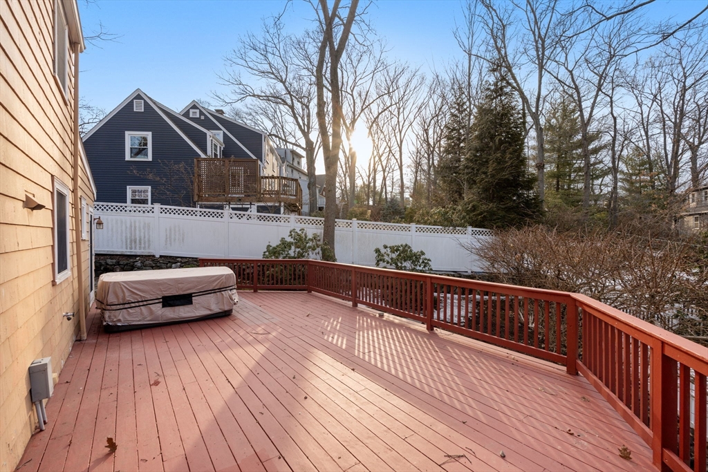 73 Roundwood Road Newton, MA 02464 - Photo 32 of 42 a view of a roof deck with wooden floor and fence