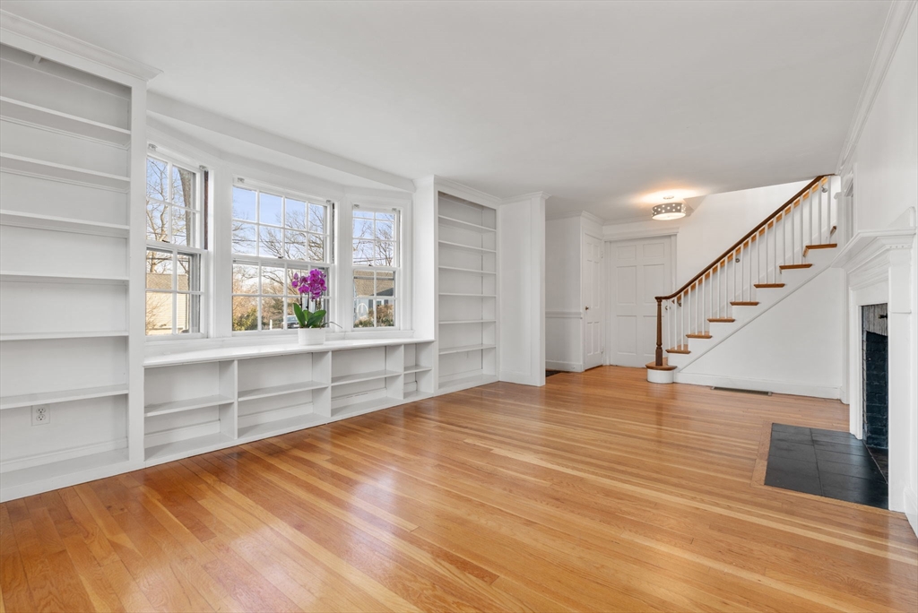 73 Roundwood Road Newton, MA 02464 - Photo 6 of 42 a view of an empty room with cabinet and wooden floor