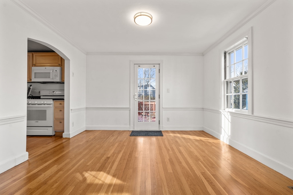 73 Roundwood Road Newton, MA 02464 - Photo 9 of 42 wooden floor in an empty room with a window and wooden floor