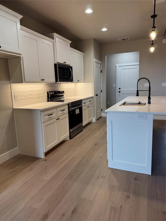 143 Ridge Road Tuscola, TX 79562 - Photo 6 of 24 a kitchen with a sink white cabinets and stainless steel appliances