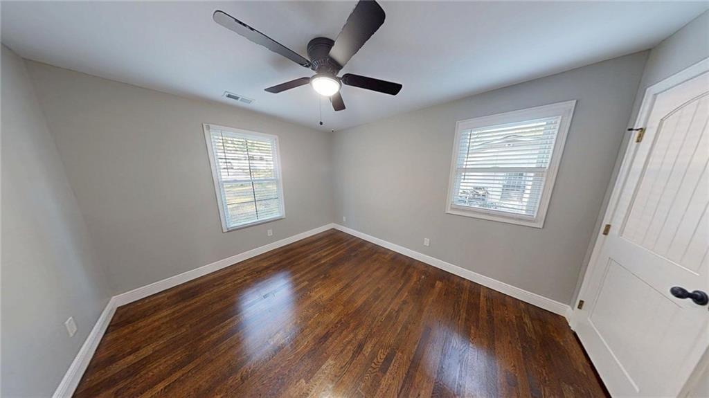 4834 Bartlett Road Forest Park, GA 30297 - Photo 13 of 20 a view of empty room with wooden floor and fan