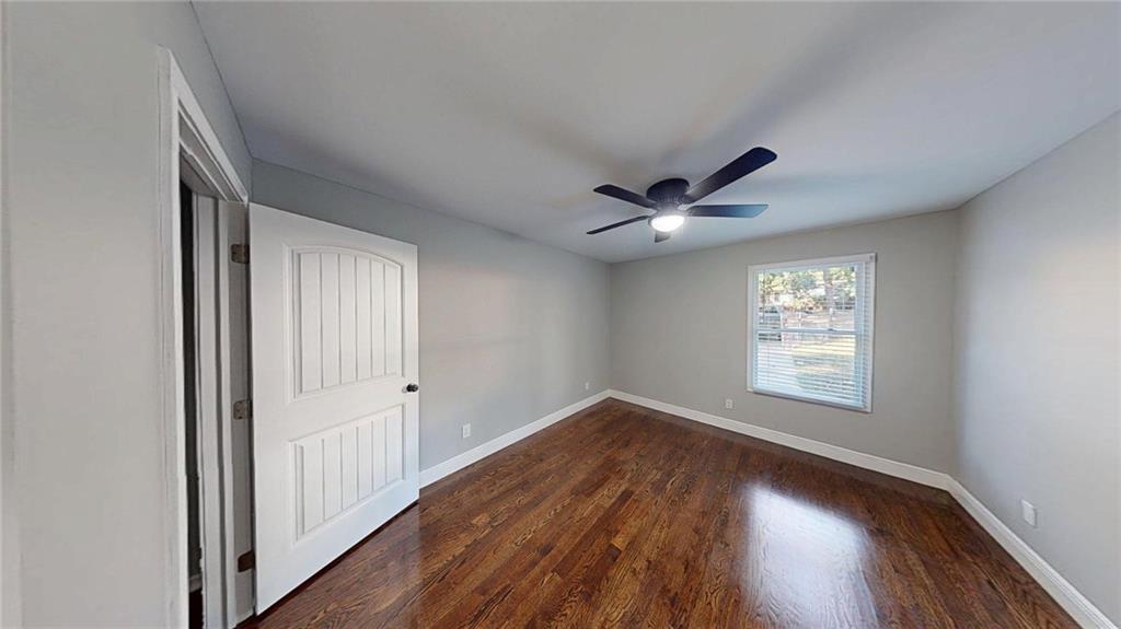 4834 Bartlett Road Forest Park, GA 30297 - Photo 8 of 20 a view of empty room with wooden floor and fan