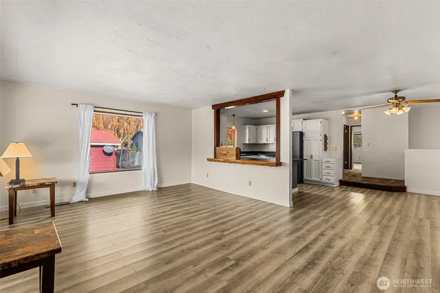 a view of empty room with wooden floor