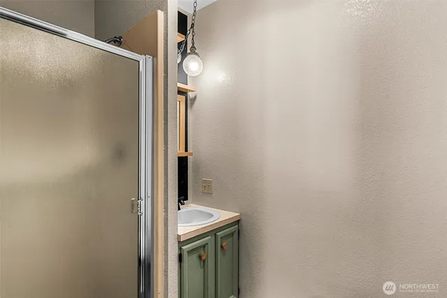a bathroom with a shower and a sink