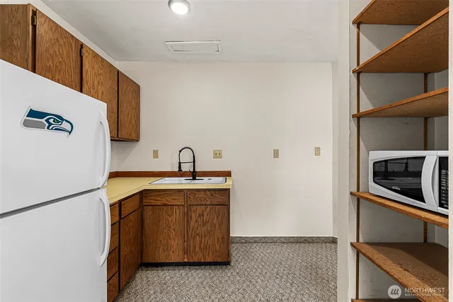 a view of a kitchen with a sink and stainless steel appliances