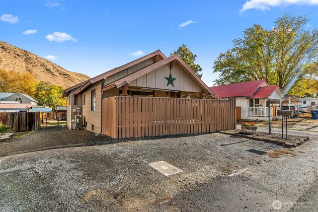 a view of a house with wooden fence