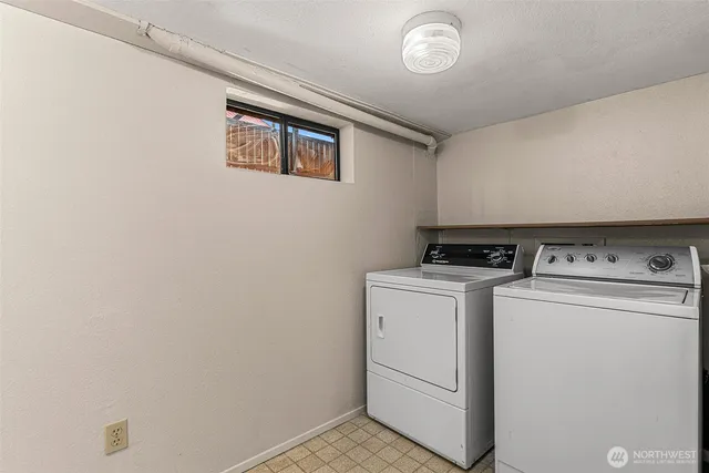 a view of a backyard with large trees and a barn