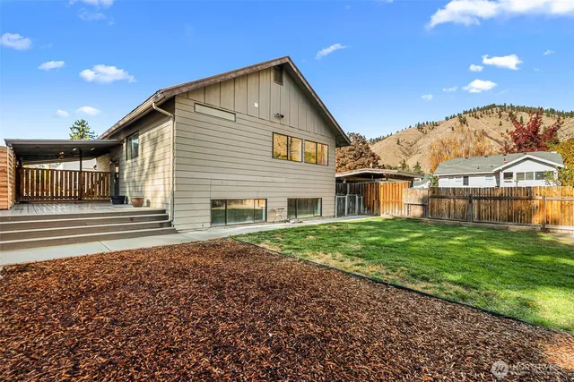 a view of a big house with a yard and plants