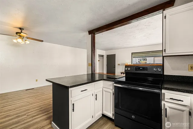 a kitchen with granite countertop cabinets a sink and appliances