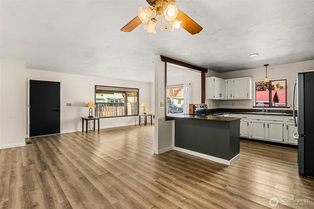 a kitchen with stainless steel appliances granite countertop a stove and cabinets