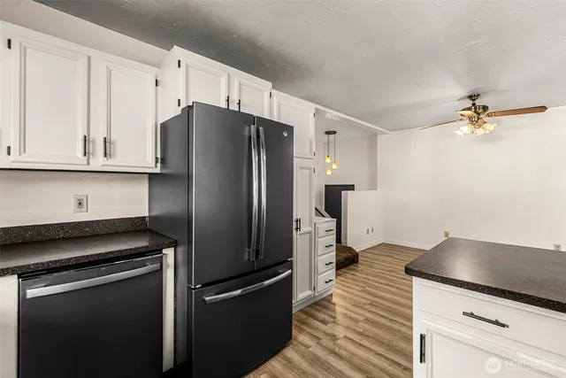 a kitchen with stainless steel appliances a refrigerator sink and cabinets