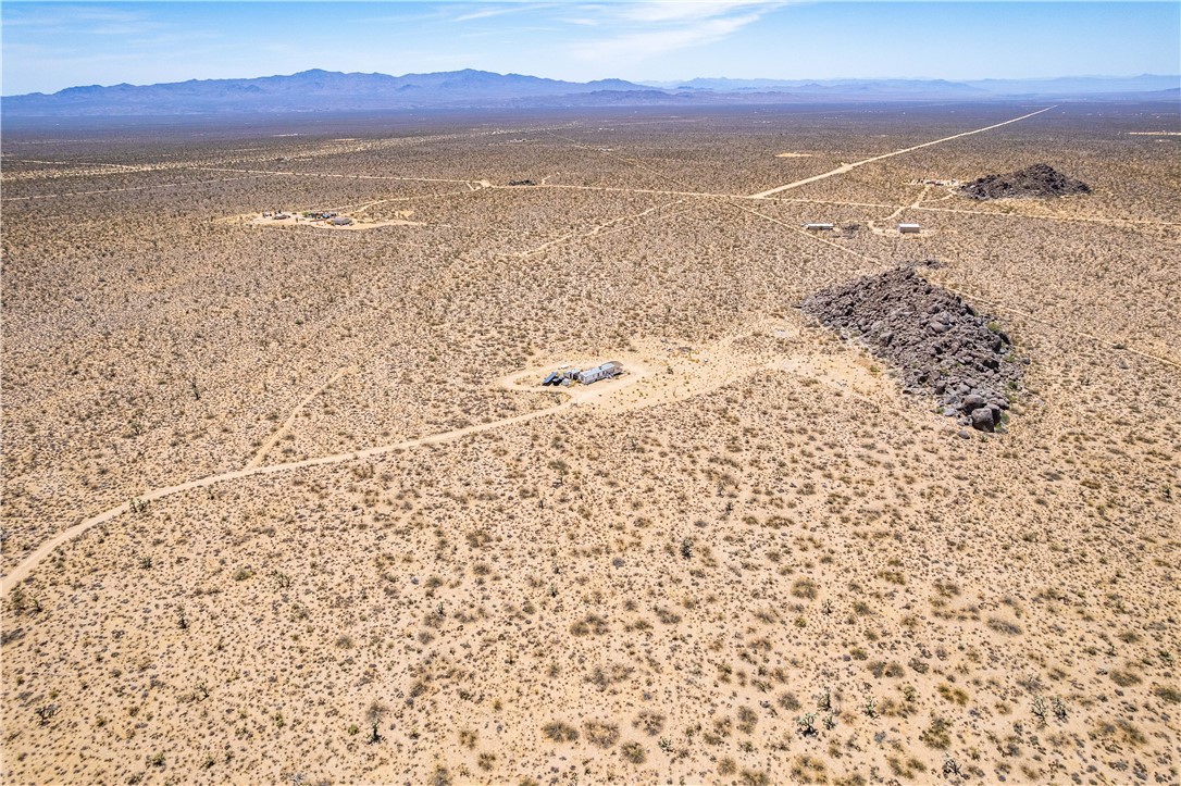 16435 South Wyatt Earp Road Yucca, AZ 86438 - Photo 50 of 57 Expansive desert landscape featuring natural rock formations and distant mountain ranges