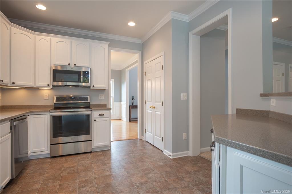 307 Prestmont Court Fort Mill, SC 29708 - Photo 8 of 38 a kitchen with a refrigerator and a stove top oven