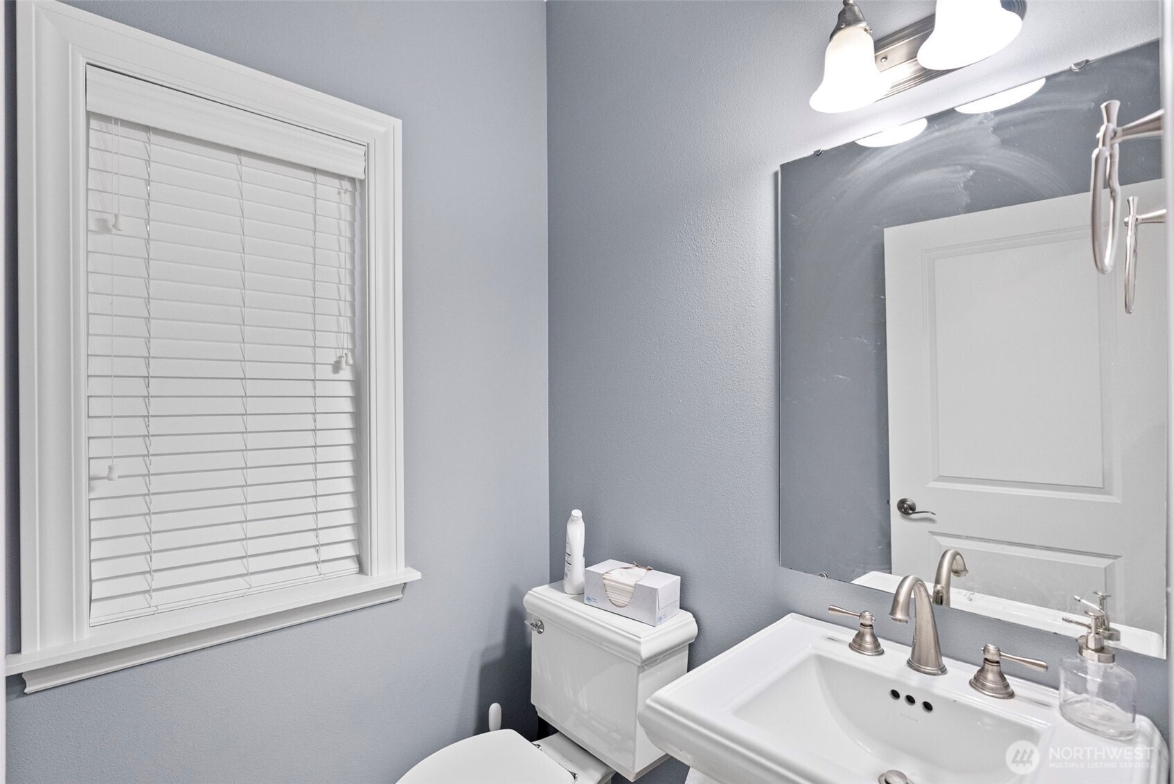 2300 Northeast Solar View Court Poulsbo, WA 98370 - Photo 13 of 28 a bathroom with a toilet a sink and mirror