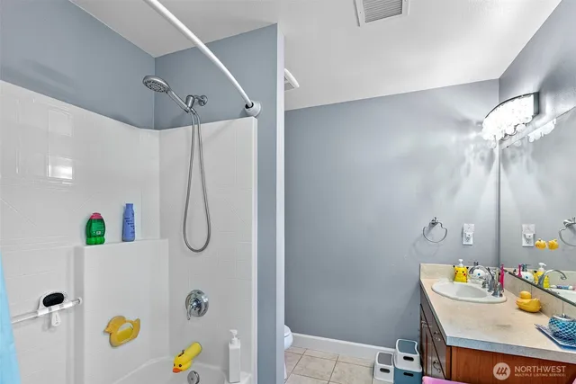 a bathroom with a sink mirror and vanity