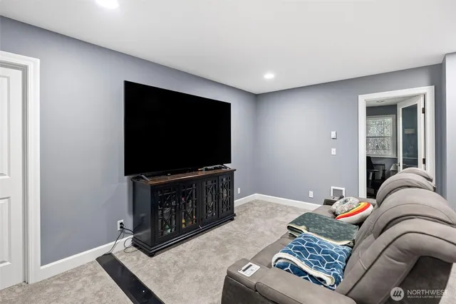 a view of a livingroom with workspace and a window