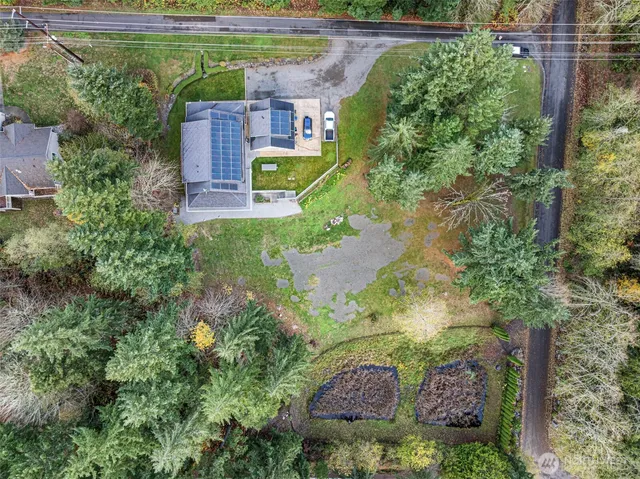 an aerial view of a house with a yard