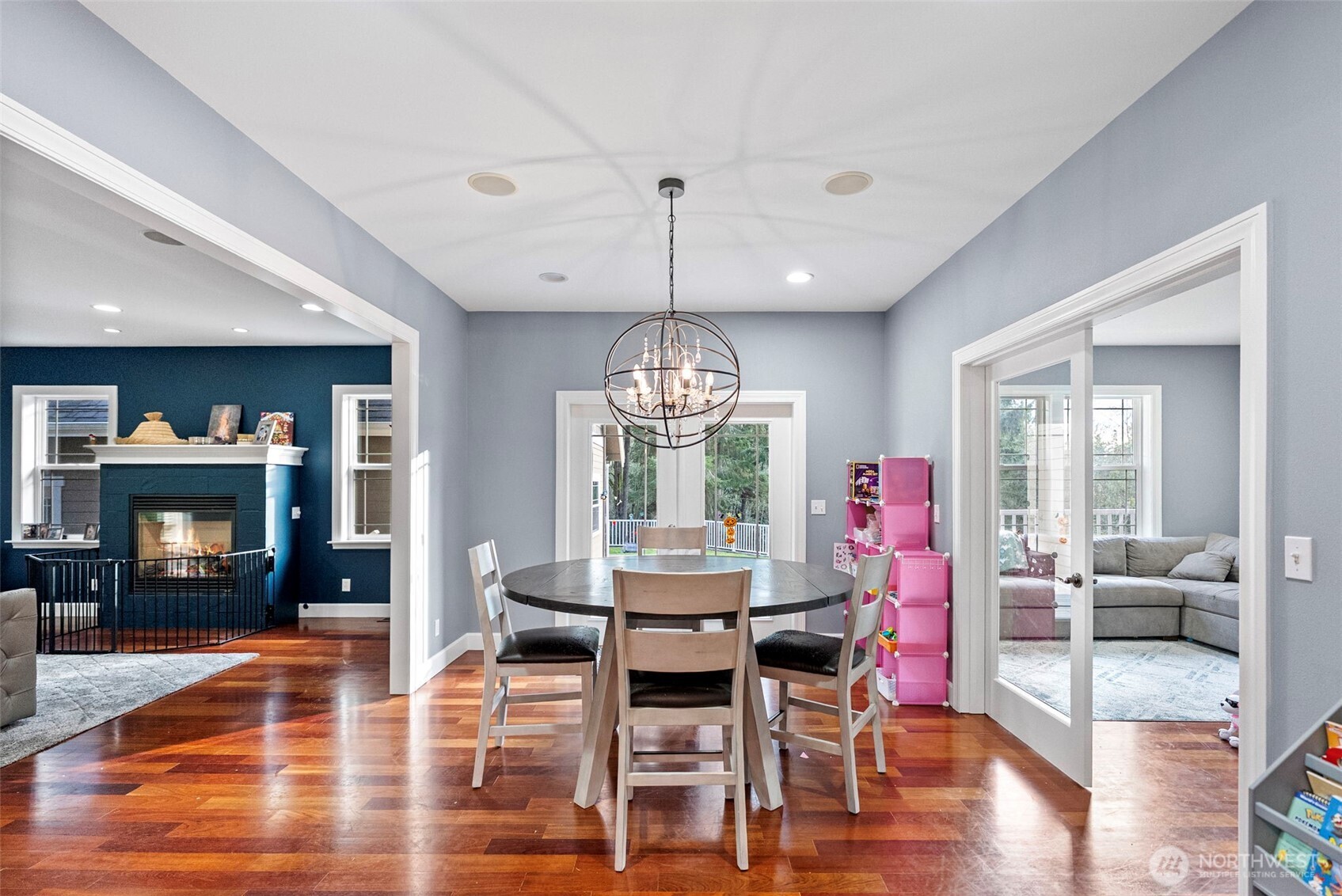 2300 Northeast Solar View Court Poulsbo, WA 98370 - Photo 10 of 28 a dining room with wooden floor a chandelier a wooden table and chairs