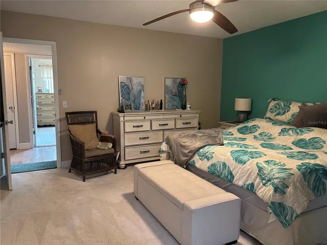 a bedroom with a bed and lamp