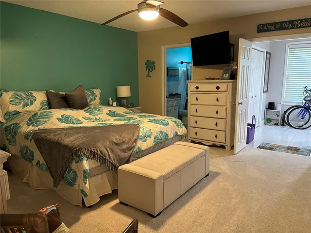 a bedroom with a bed and flat screen tv