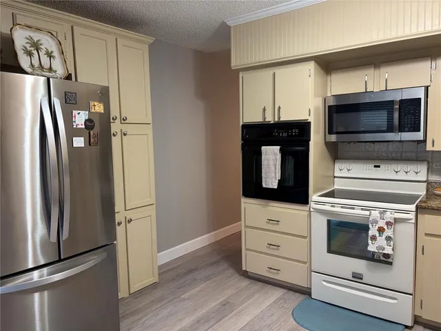 a kitchen with granite countertop cabinets and steel stainless steel appliances