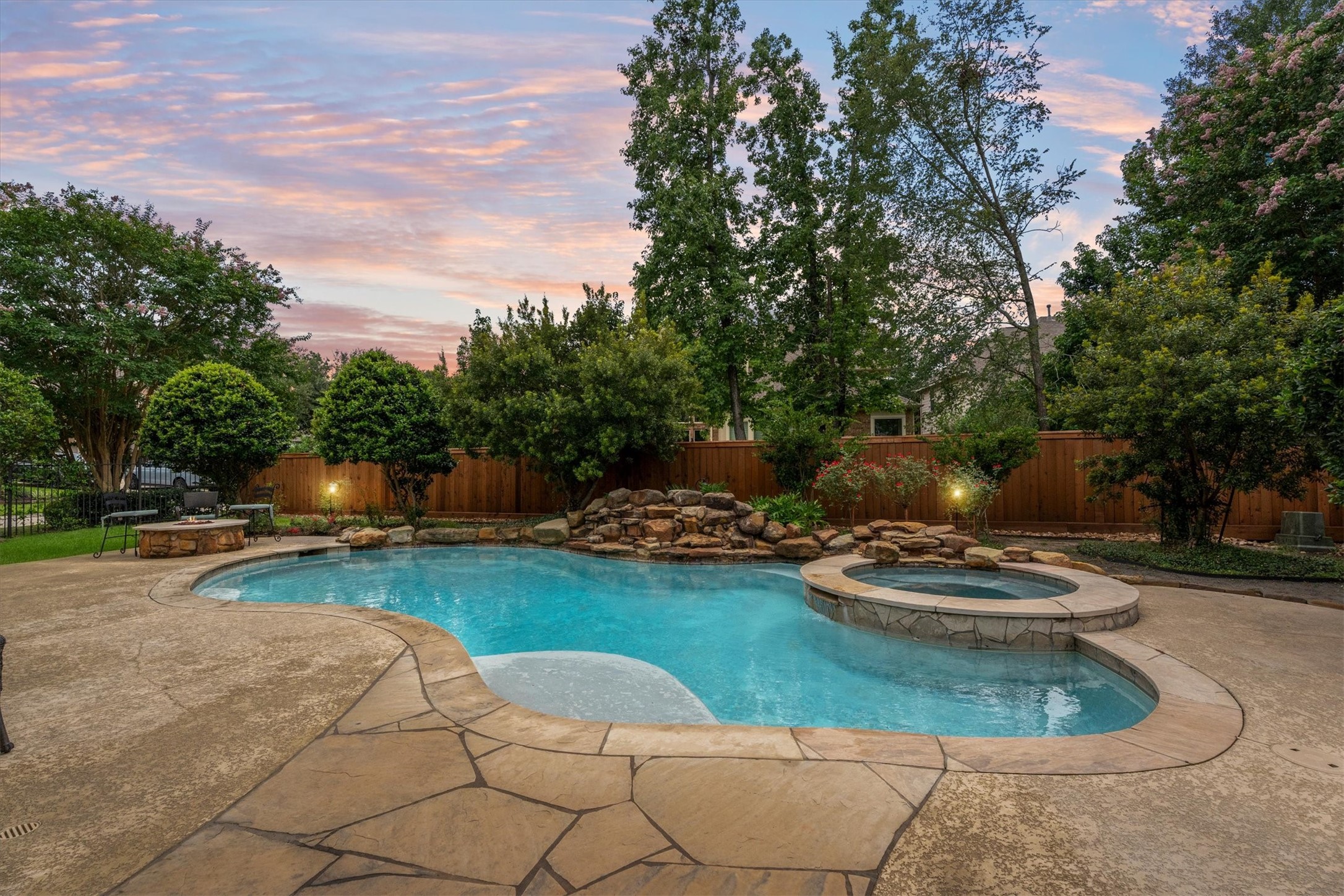 3 Indigo Bunting Place Spring, TX 77389 - Photo 1 of 41 Relax in the inviting pool with a connected spa and cascading waterfall, surrounded by lush landscaping and mature trees for a tranquil, private outdoor retreat.