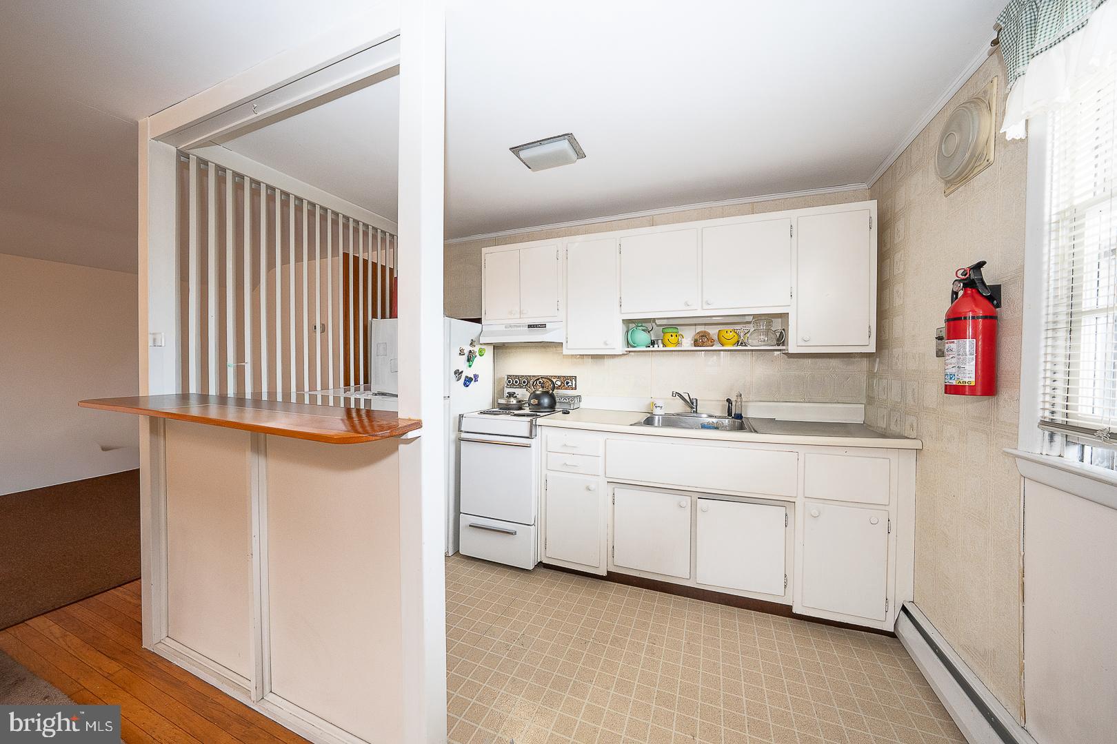 11 Tenby Road Havertown, PA 19083 - Photo 42 of 62 a kitchen with granite countertop white cabinets and white appliances