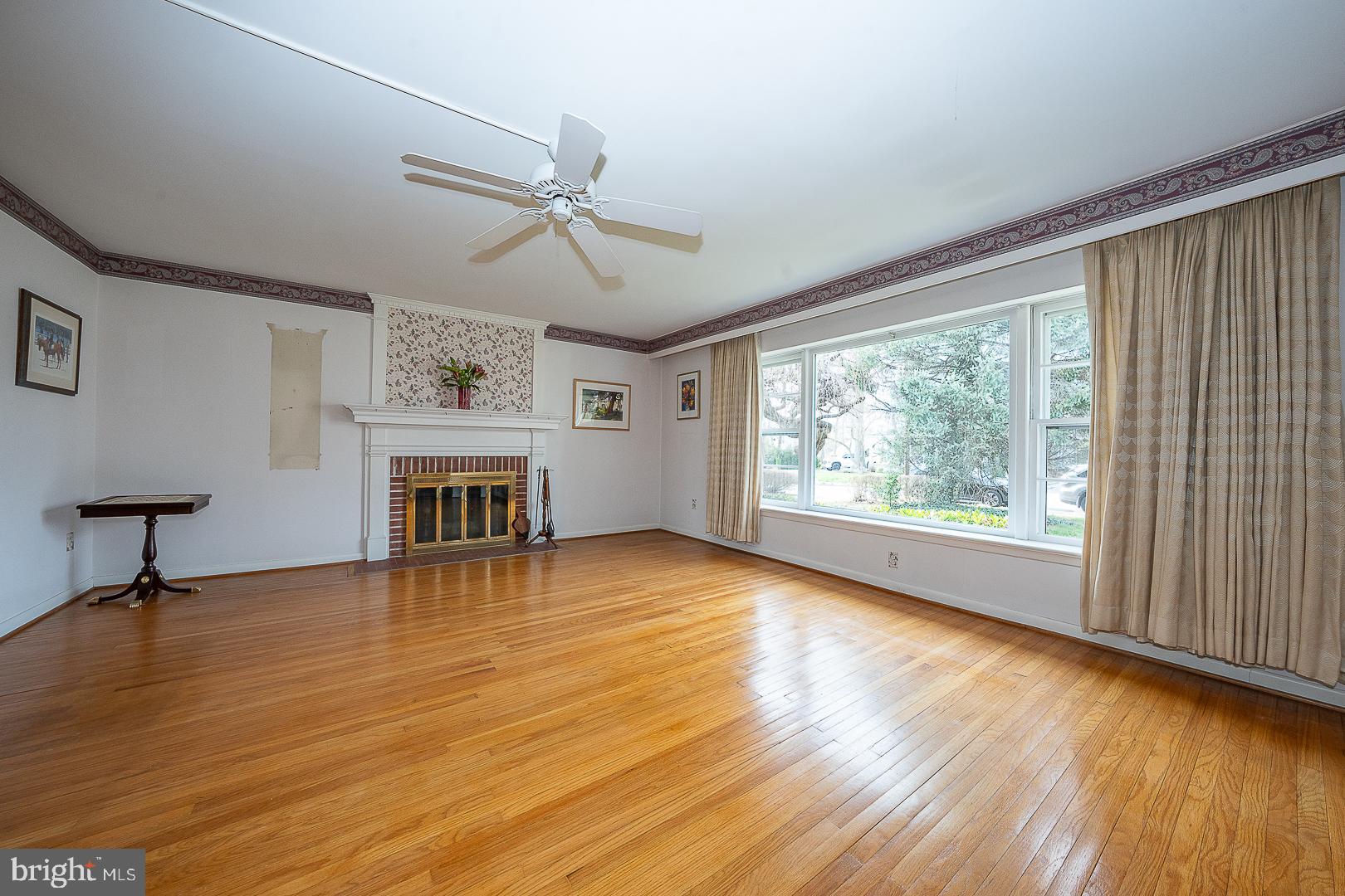 11 Tenby Road Havertown, PA 19083 - Photo 7 of 62 a view of empty room with fireplace and wooden floor
