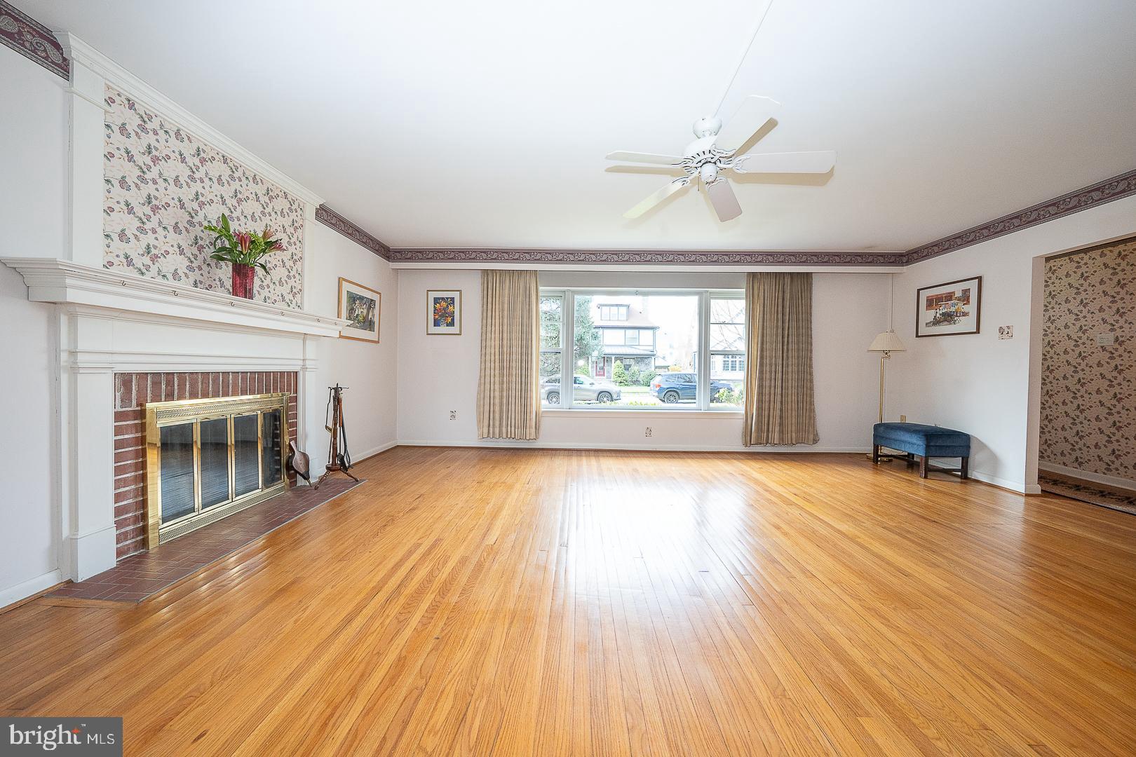 11 Tenby Road Havertown, PA 19083 - Photo 9 of 62 an empty room with windows fireplace and wooden floor