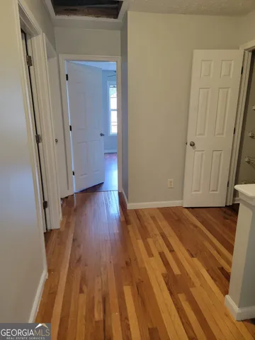 a view of a room with wooden floor and staircase