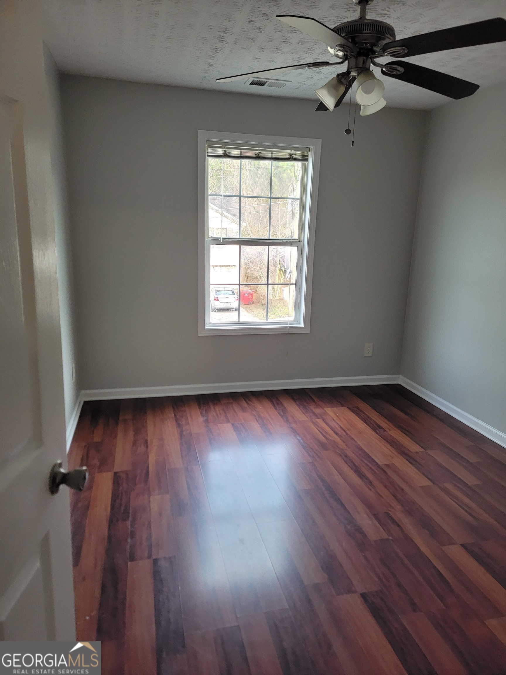 4107 Shining Armor Drive Conley, GA 30288 - Photo 13 of 14 wooden floor in an empty room with a window