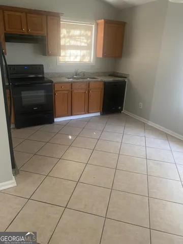 a kitchen with cabinets and appliances