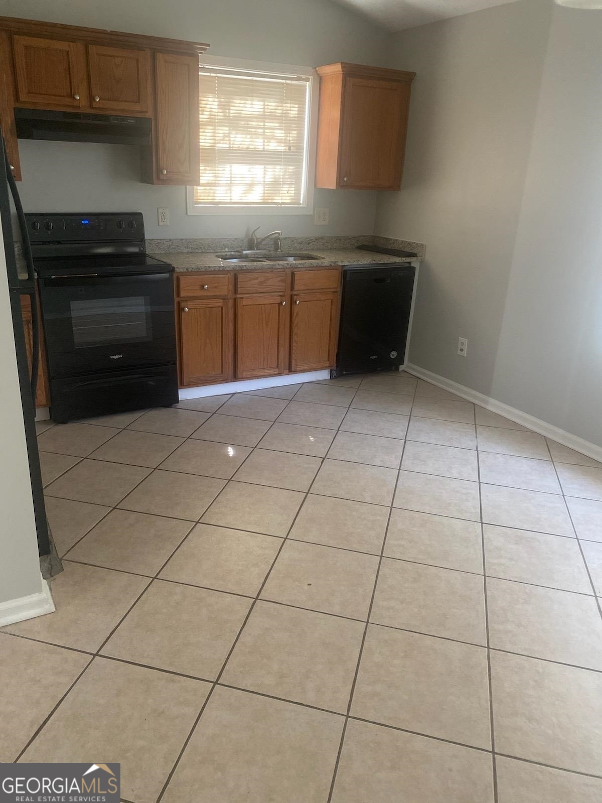 4107 Shining Armor Drive Conley, GA 30288 - Photo 3 of 14 a kitchen with cabinets and appliances