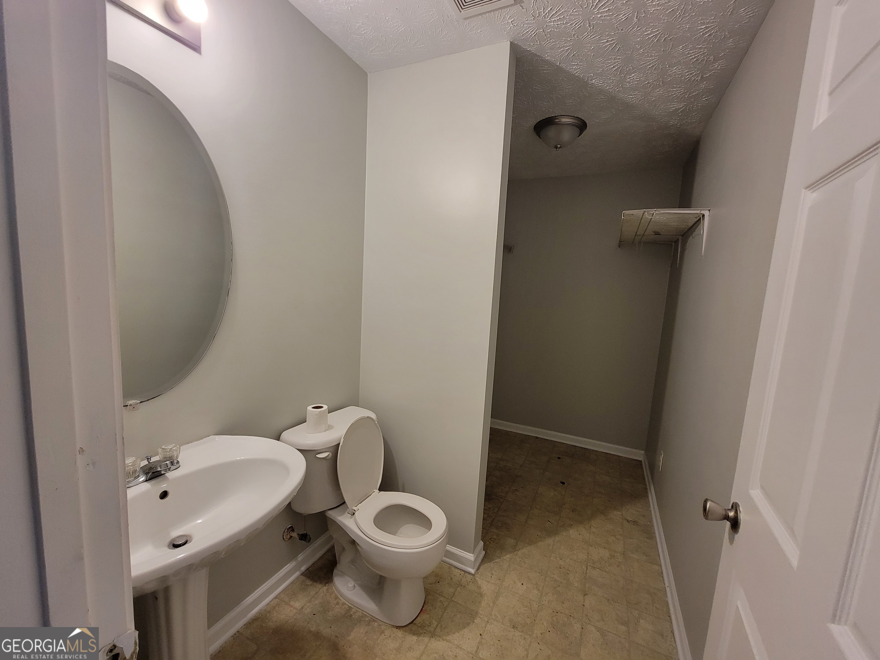 4107 Shining Armor Drive Conley, GA 30288 - Photo 5 of 14 a white toilet sitting next to a bathroom sink