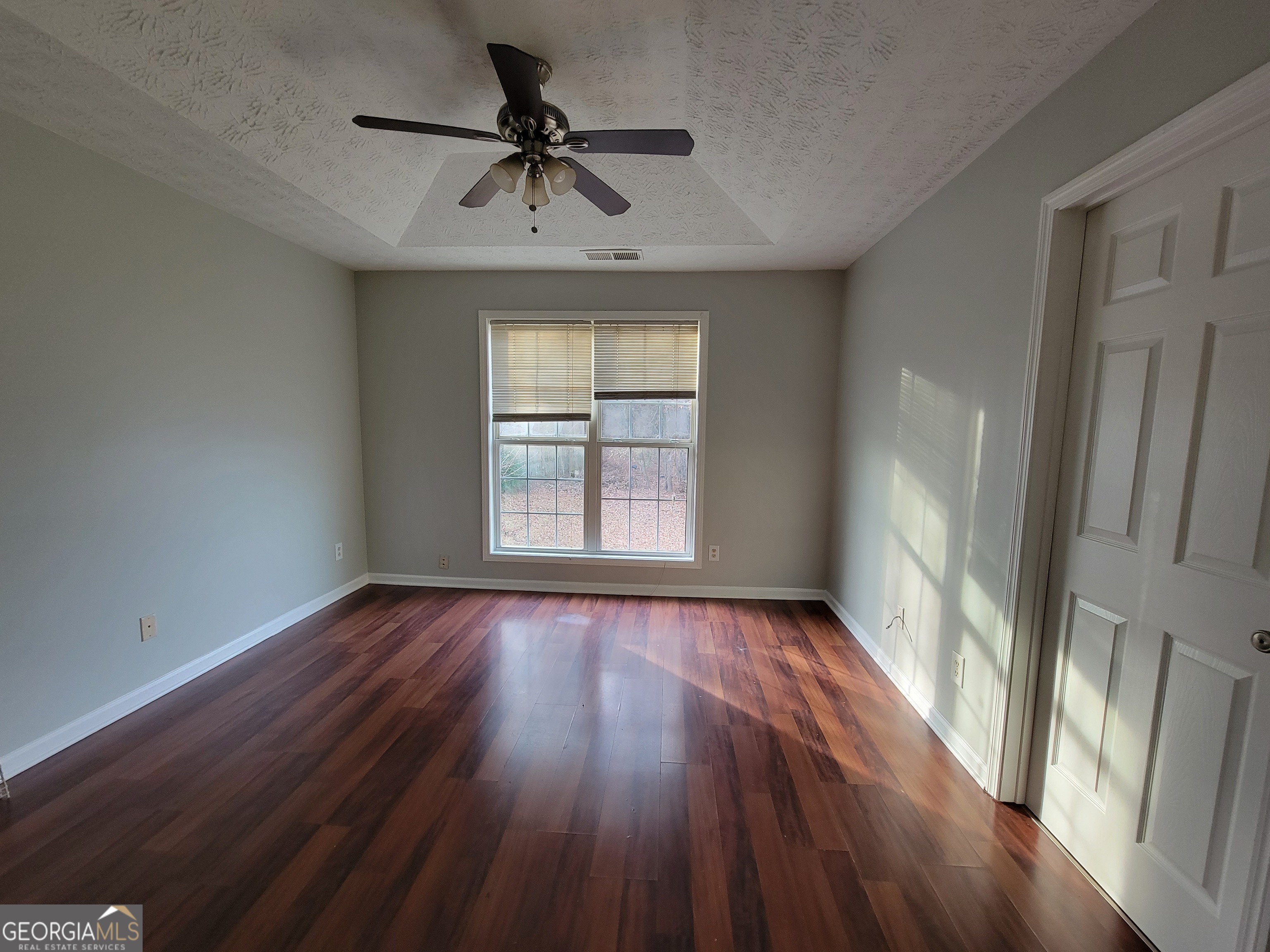 4107 Shining Armor Drive Conley, GA 30288 - Photo 8 of 14 a view of an empty room with wooden floor and a window