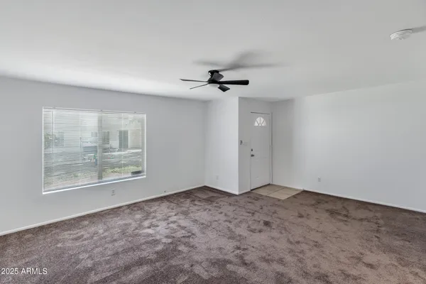 a view of an empty room with a window