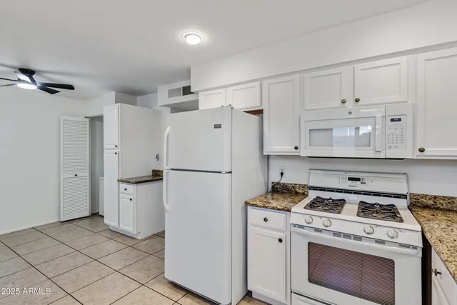 a kitchen with a stove a refrigerator and a sink